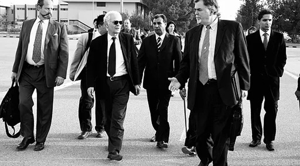 The Protector Dr Mary Beth walks with men in black suits